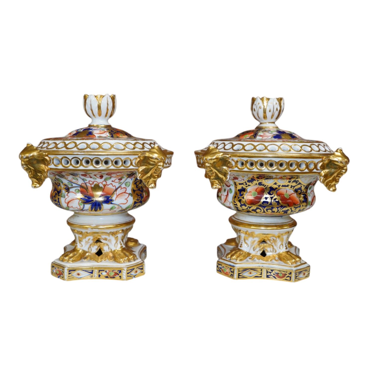 A pair of Derby Imari pattern pot pourri pots and covers, 14cm high. Condition - gilding worn in places and one pot has two fine cracks to interior top edge and flower, a few finial petals are damaged